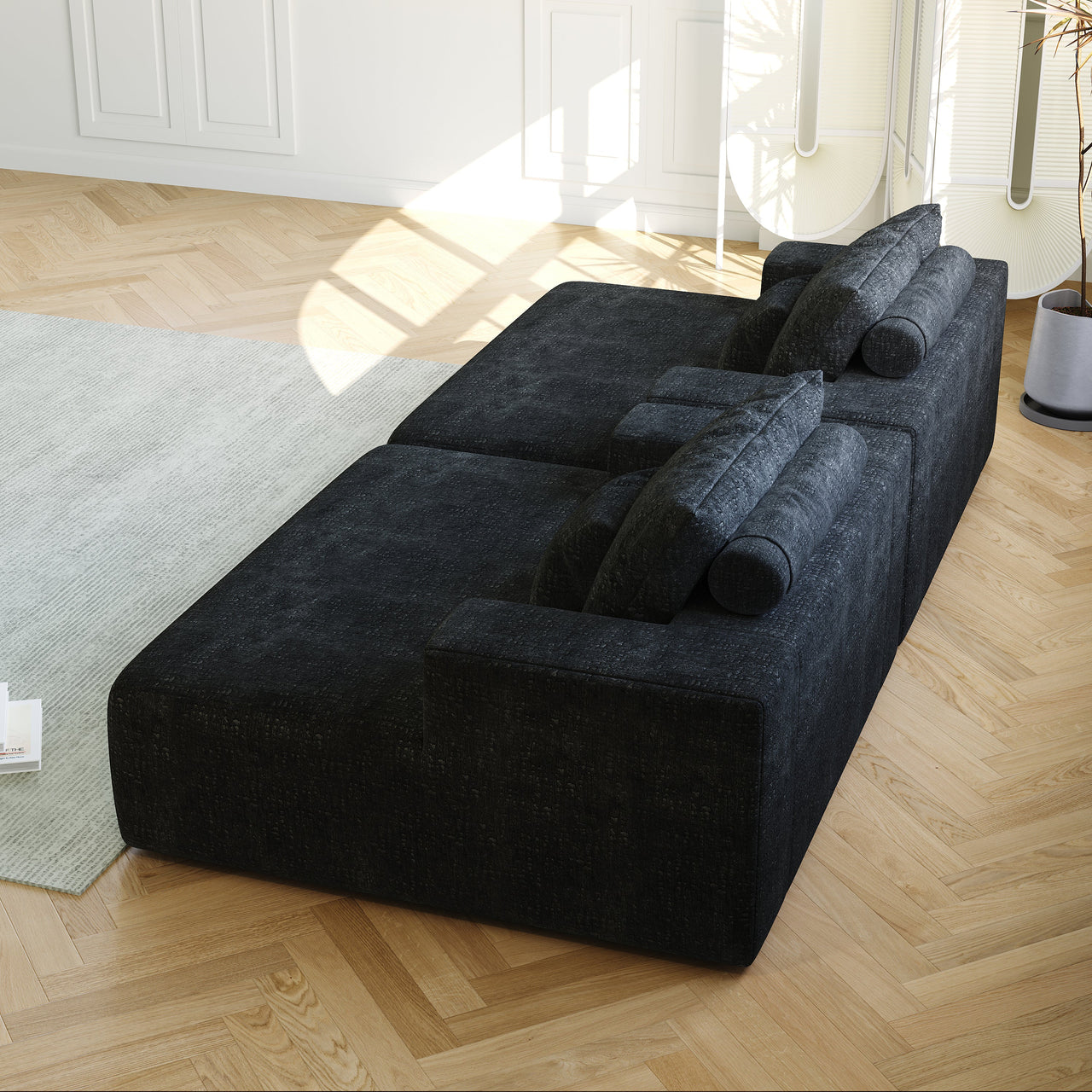 Dark gray/black modular sofa close-up with three cushions